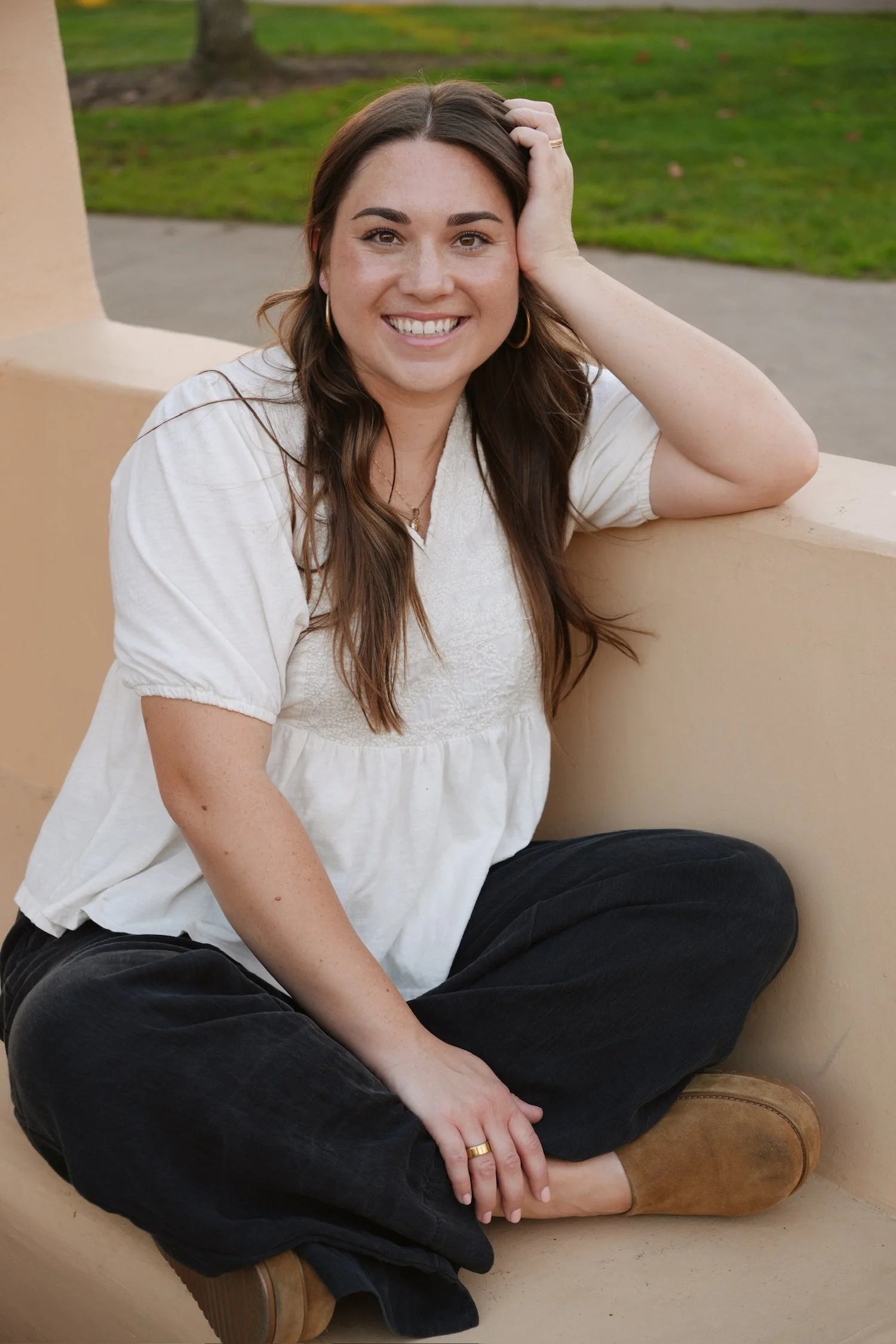 Faith Vargas seated on an outdoor bench, smiling