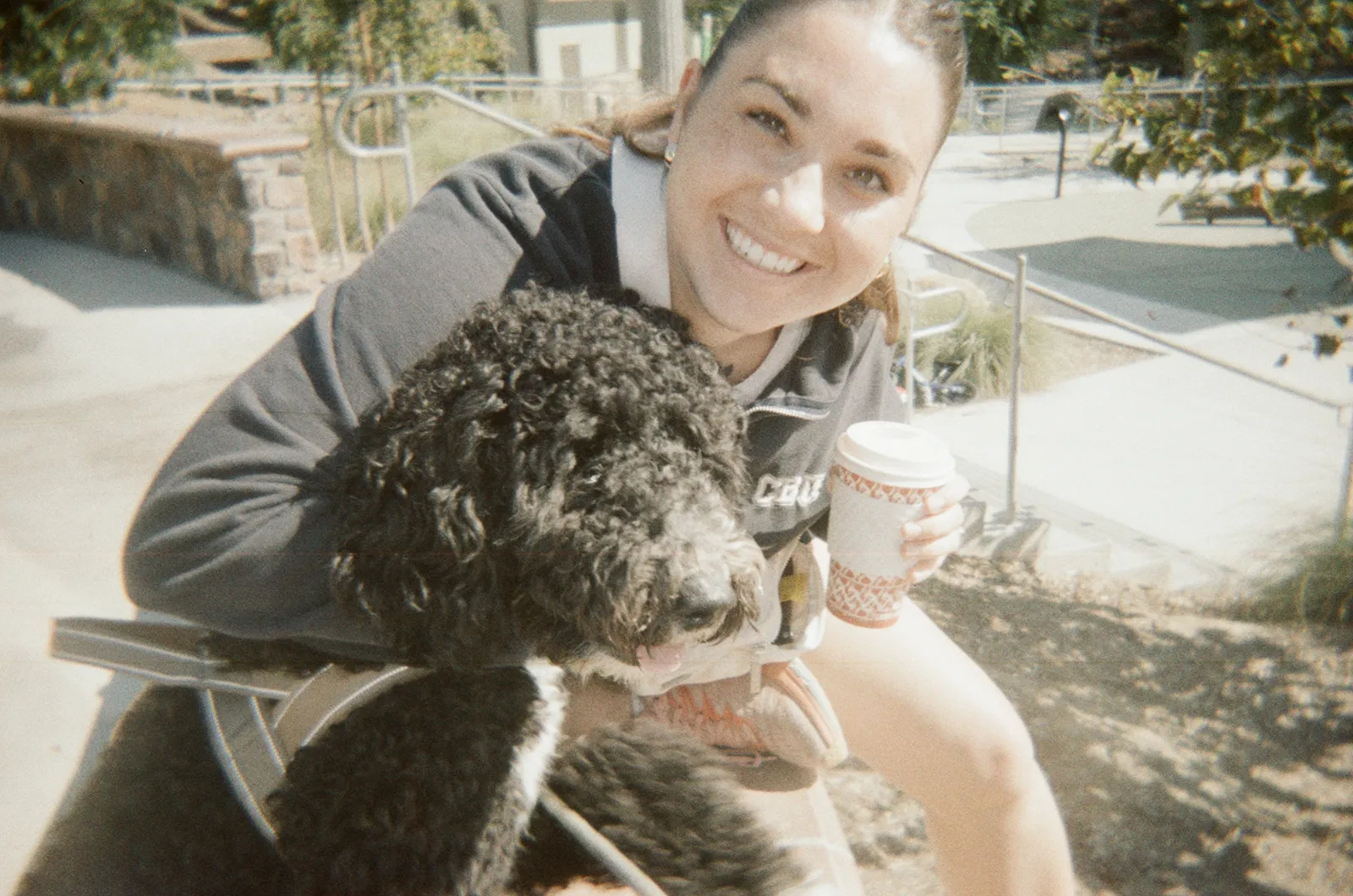 Faith with Sox, her curly black-and-white dog